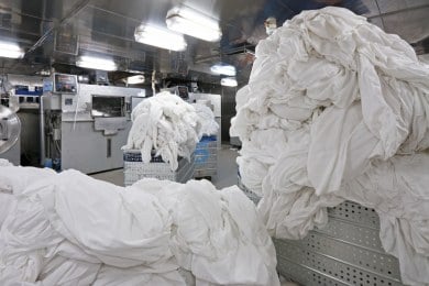 Commercial laundry service at Bright Wash New Lynn laundromat handling large volumes of linen and towels