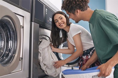 Customers using Speed Queen washing machines at Bright Wash self-service laundromat in New Lynn laundromat