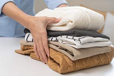 Folded clean laundry ready for pickup and delivery from New Lynn Laundromat -- Bright Wash